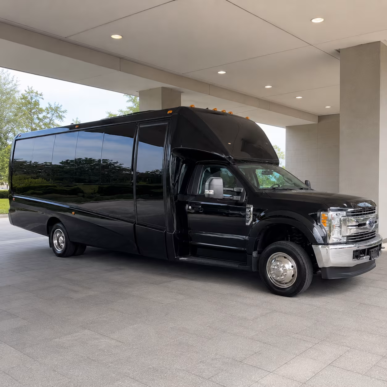 Group beside a Mercedes Sprinter limo in Fresno